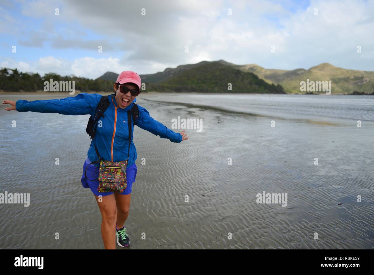 A Women Walking Into The Wind On A Beach Hiking Through Cape