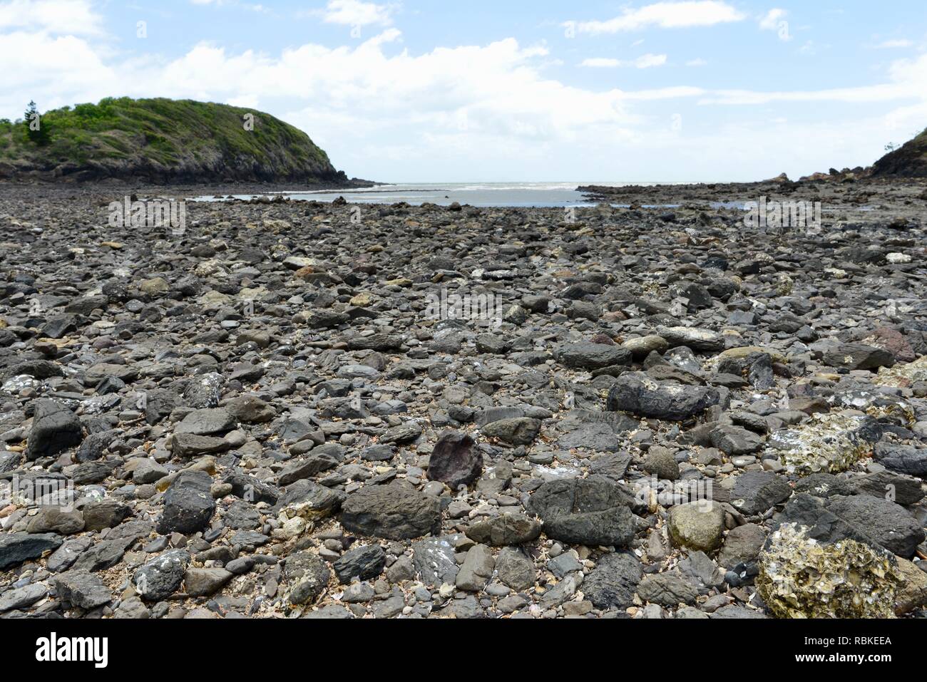 The rocky causeway connecting wedge island to the mainland, Hiking through Cape Hillsborough National Park, Queensland, Australia Stock Photo
