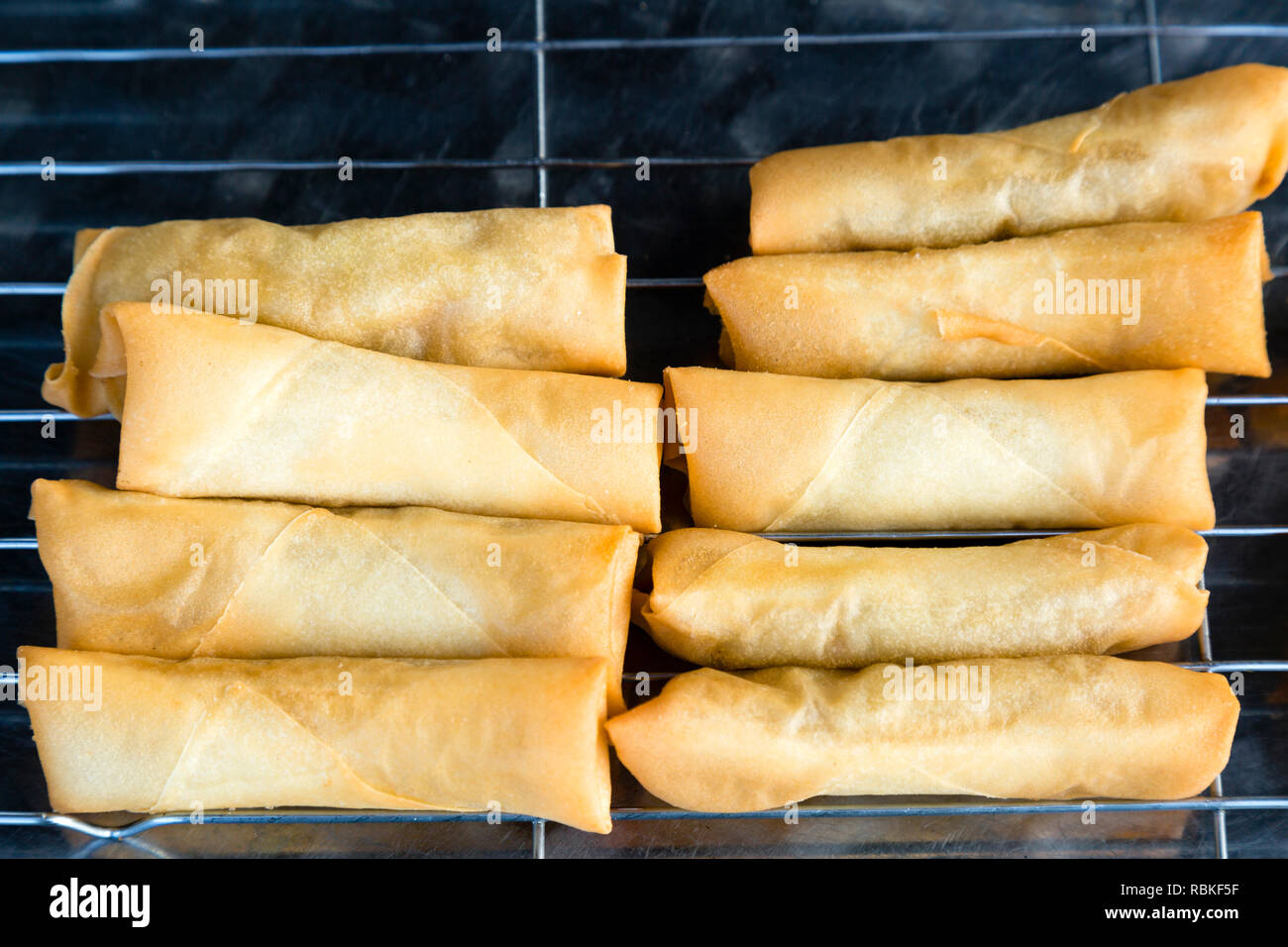 Spring rolls also known as popiah are a large variety of filled, rolled appetizers or dim sum found in East Asian, South Asian, and Southeast Asian cu Stock Photo