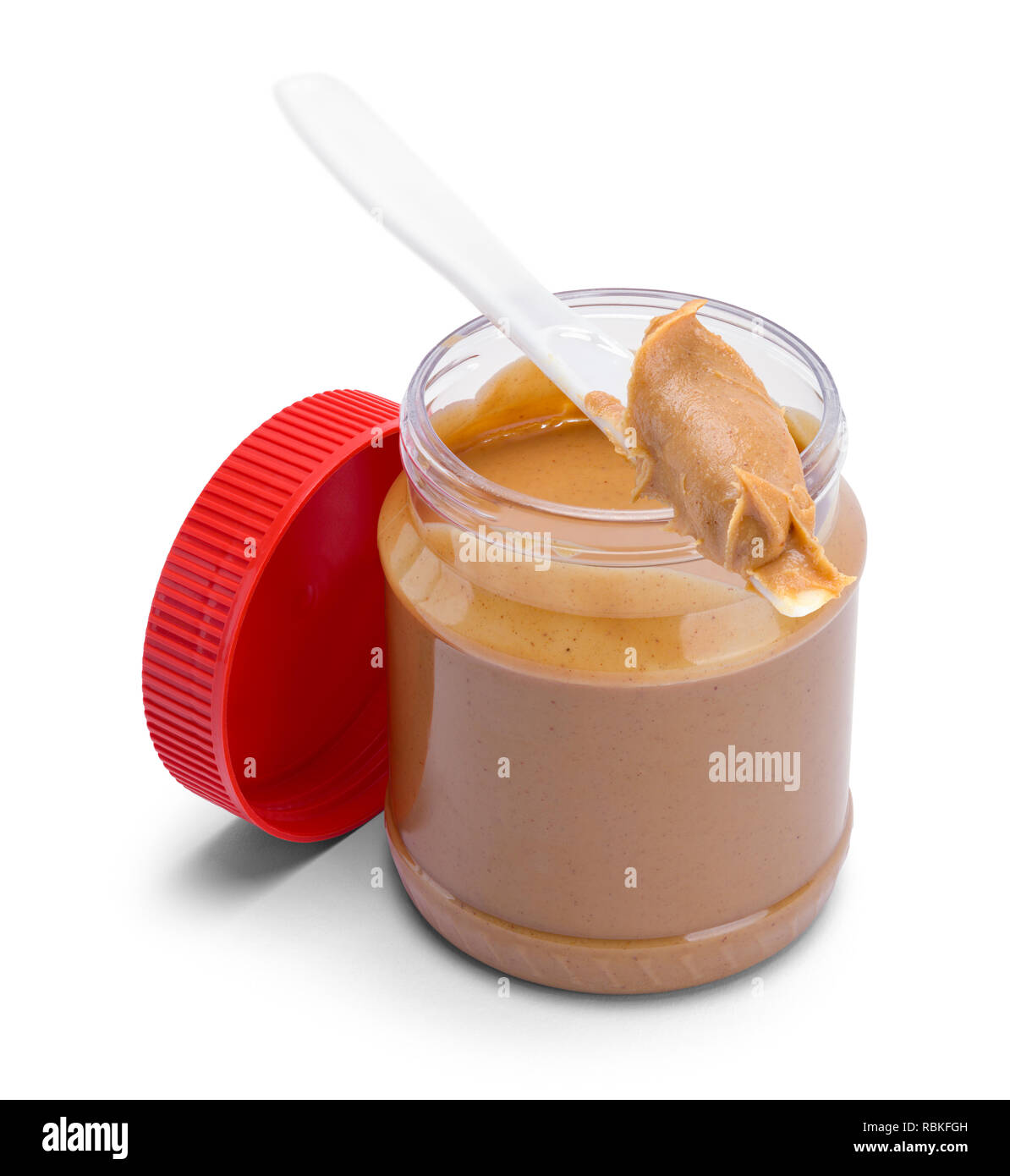 An opened jar of peanut butter with a small spoon Stock Photo