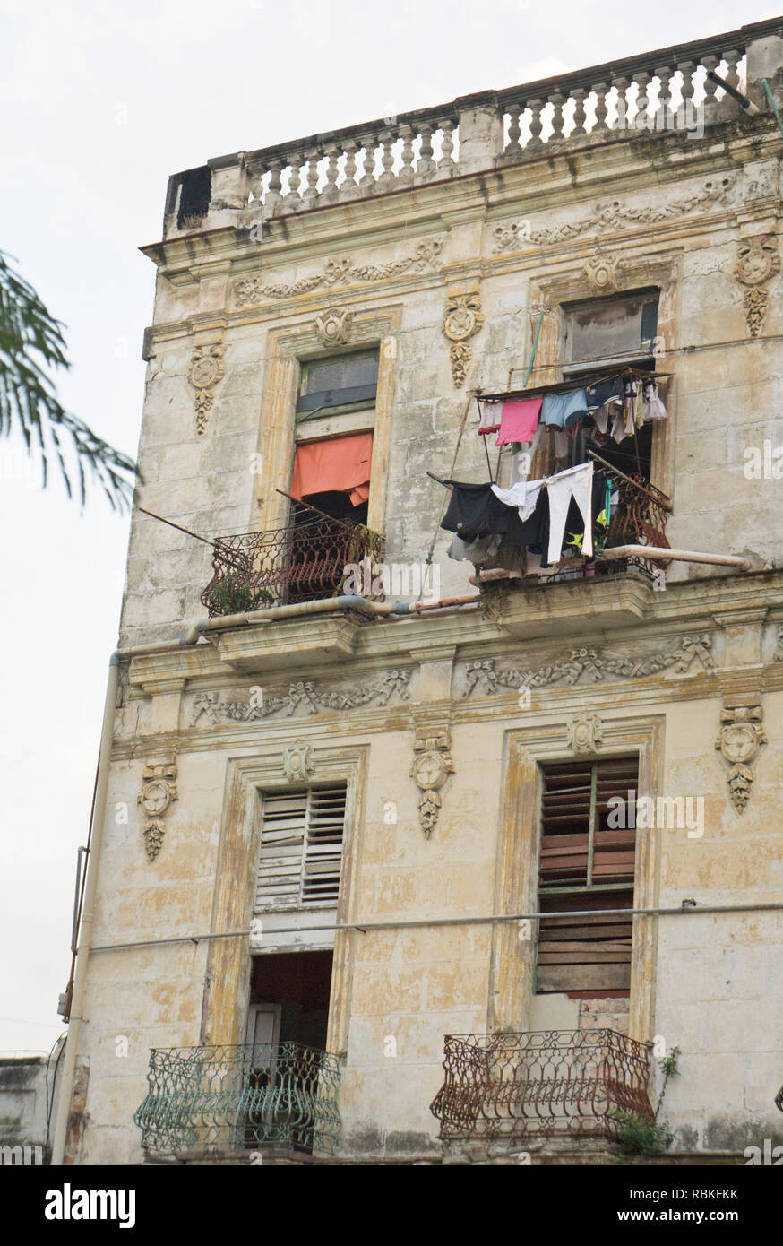 laundry hung outside windows common sight in Old Havana where elegant mansions were confiscated for apartments & facades oddly preserved by neglect Stock Photo