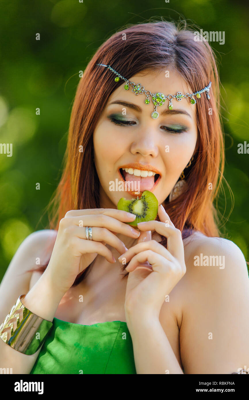 Portrait of a beautiful young asian woman in green dress and diadema on ...