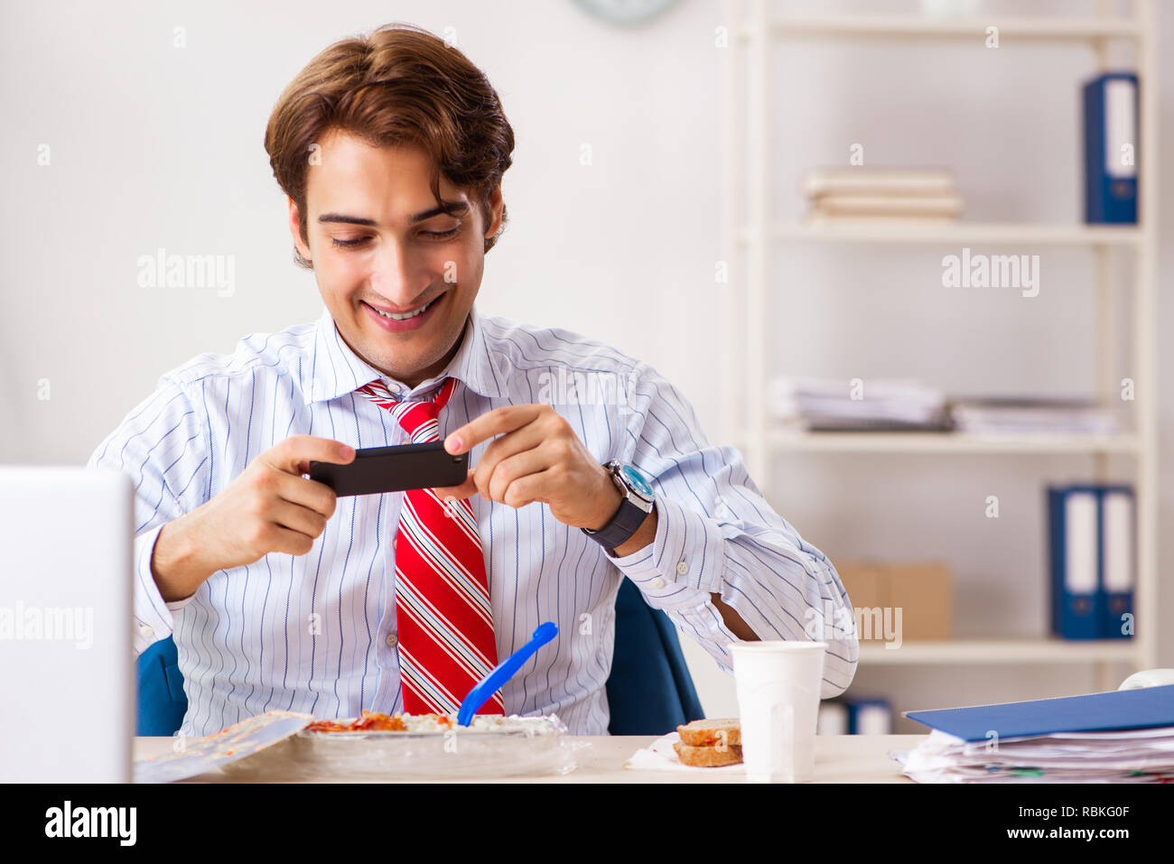Man having meal at work during break Stock Photo - Alamy