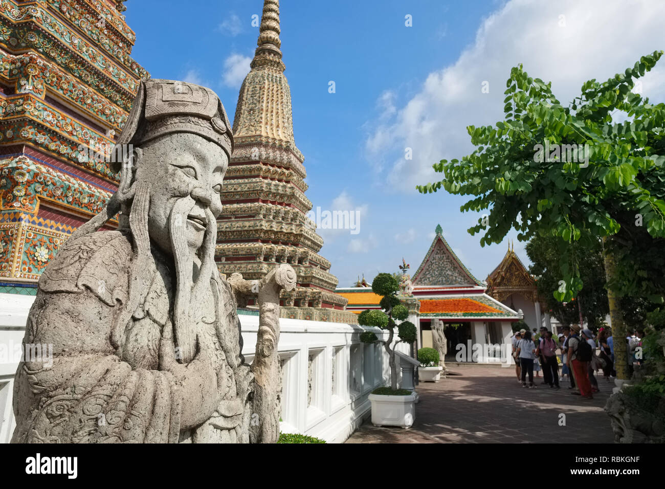 A Chinese figure in the grounds of Wat Po (Pho) Bangkok, Thailand, the site of the famous Reclining Buddha Stock Photo