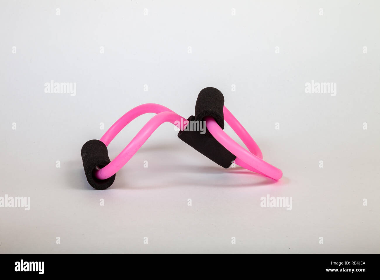 Pink rubber tube expander with black paralon handles for performing