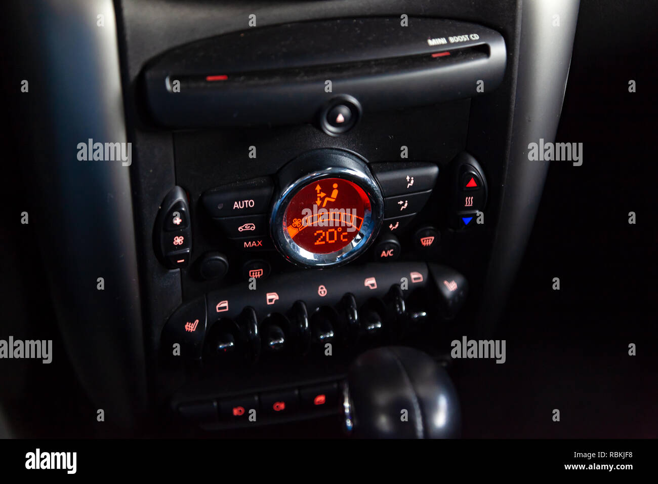 Air conditioning on the dashboard climate control car inside the cabin close-up with red illumination of buttons and levers with a display that measur Stock Photo