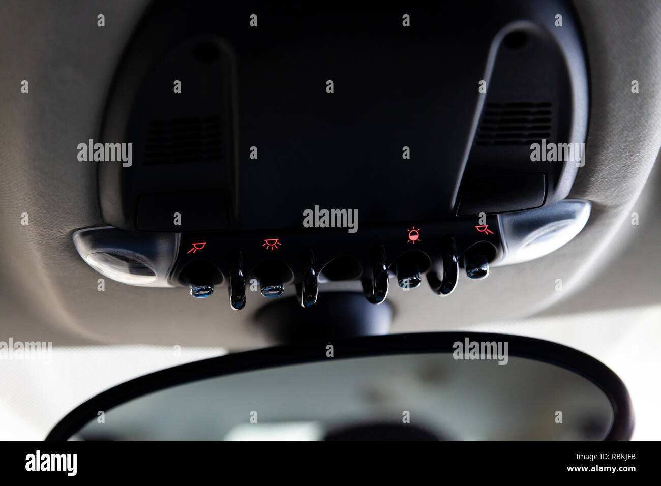 Lighting control inside the car from the top on the instrument panel behind the rearview mirror