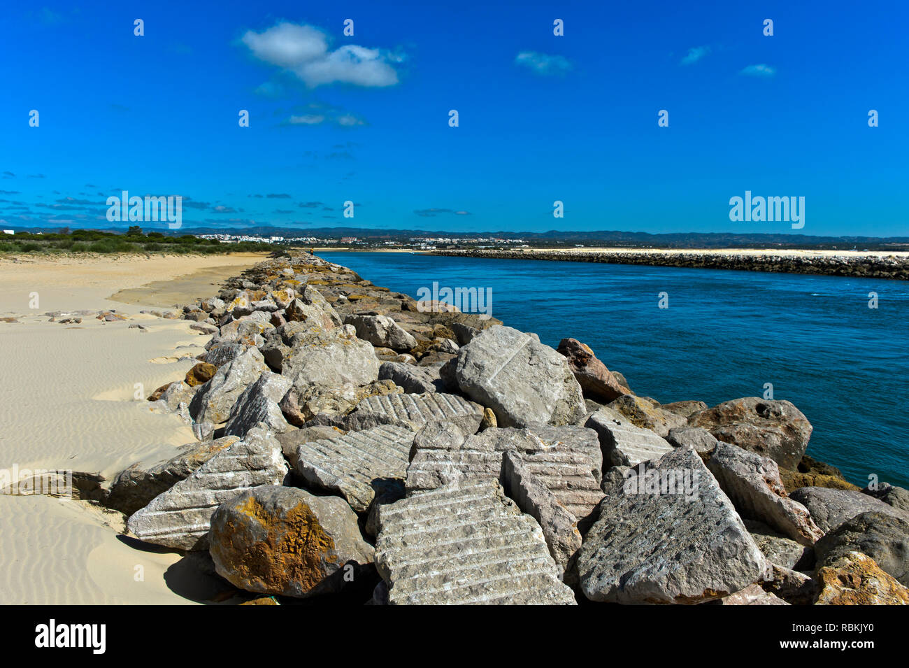Boulders as protection of the litoral zone against rising sea levels at the mouth of the Gilao River, Tavira Island, Ilha de Tavira, Tavira, Algarve,  Stock Photo