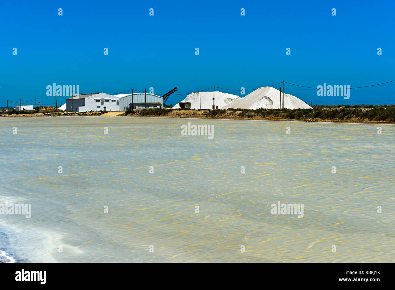 Sea salt production, salt evaporation ponds, Sopursal saline, Santa Luzia, Algarve, Portugal Stock Photo