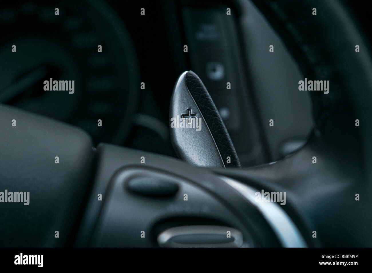 Shift paddles. Steering wheel with shift paddles. Manual gear changing stick  on a car's steering wheel Stock Photo - Alamy