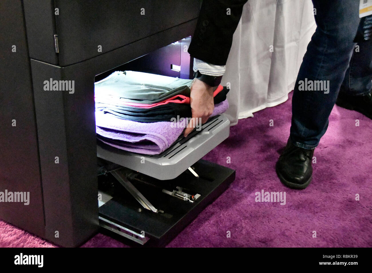 Gal Rozov of FoldiMate shows their folding shirts, towels and pressing  machine that will be out before end of the year during the third day of the  2019 CES show Thursday. CES