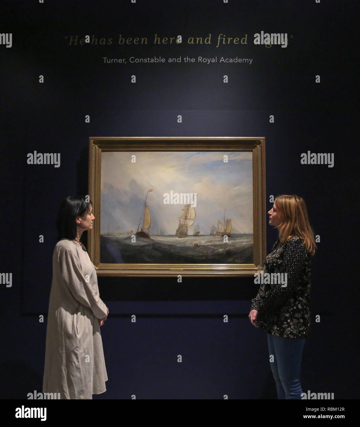 London, UK. 11th Jan, 2019. Staff members seen viewing a painting by J.M.W. Turner.The Royal Academy Schools' most illustrious graduates, exhibits Helvoetsluys ('Helvoetsluys; - the City of Utrecht, 64, going to sea') 1832 by J.M.W. Turner (1775-1851) and The opening of Waterloo Bridge ('Waterloo Bridge, from the Whitehall Stairs, 18th June 1817) by John Constable (1776-1837), in, are-telling of one of the most legendary events in the history of the Summer Exhibition, it toke place at the Royal Academy of Arts. The two paintings were reunited for the first time since the Stock Photo