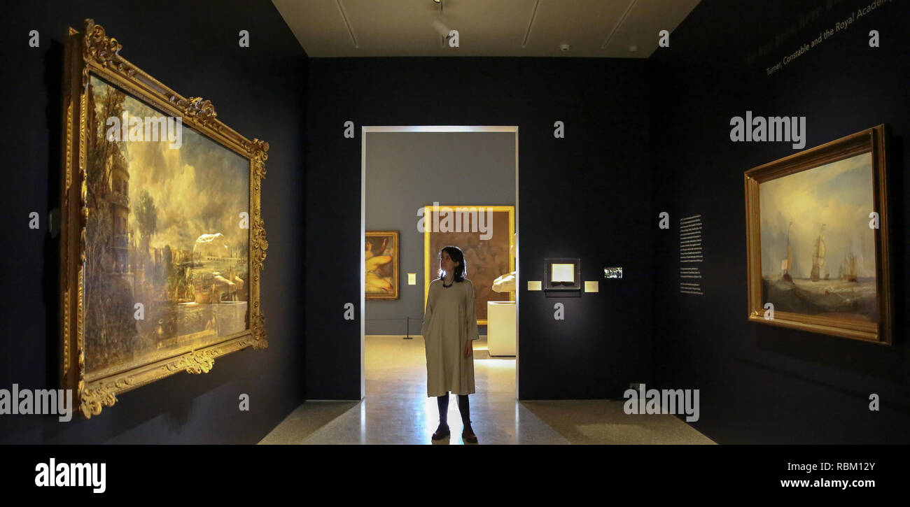 London, UK. 11th Jan, 2019. A staff member seen viewing paintings by John Constable and J.M.W Turner.The Royal Academy Schools' most illustrious graduates, exhibits Helvoetsluys ('Helvoetsluys; - the City of Utrecht, 64, going to sea') 1832 by J.M.W. Turner (1775-1851) and The opening of Waterloo Bridge ('Waterloo Bridge, from the Whitehall Stairs, 18th June 1817) by John Constable (1776-1837), in, are-telling of one of the most legendary events in the history of the Summer Exhibition, it toke place at the Royal Academy of Arts. The two paintings were reunited for the fir Stock Photo