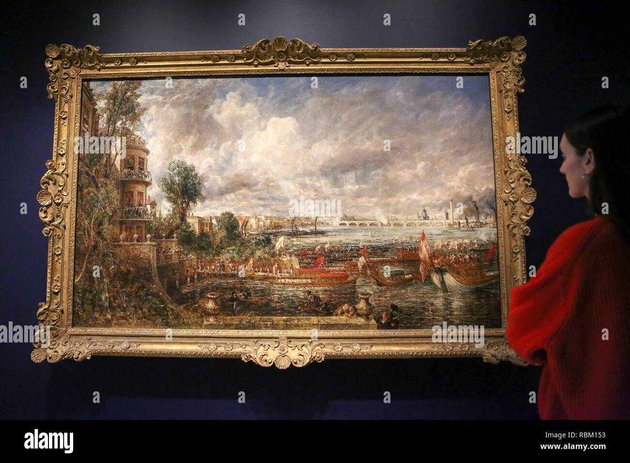London, UK. 11th Jan, 2019. A staff member seen viewing a painting by John Constable.The Royal Academy Schools' most illustrious graduates, exhibits Helvoetsluys ('Helvoetsluys; - the City of Utrecht, 64, going to sea') 1832 by J.M.W. Turner (1775-1851) and The opening of Waterloo Bridge ('Waterloo Bridge, from the Whitehall Stairs, 18th June 1817) by John Constable (1776-1837), in, are-telling of one of the most legendary events in the history of the Summer Exhibition, it toke place at the Royal Academy of Arts. The two paintings were reunited for the first time since th Stock Photo