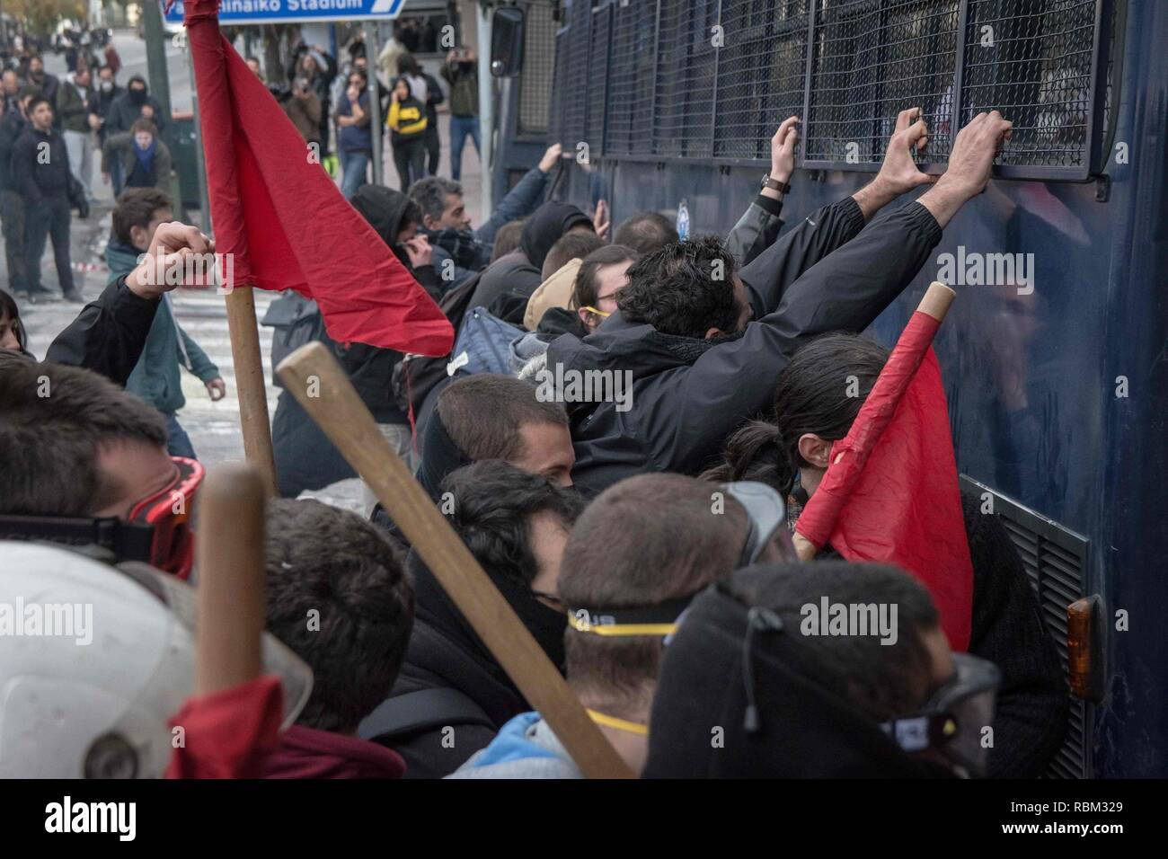 Athens, Greece. 11th Jan, 2019. Protesters are seen pushing a police bus during the protest.Thousands of people protest to withdraw the Ministry of Education's plan on the new system of the 15,000 recruits. Credit: Nikolas Joao Kokovlis/SOPA Images/ZUMA Wire/Alamy Live News Stock Photo