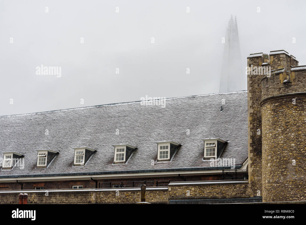 Snow in London. The roofs of Tower of London covered in fresh white snow. In the background the Shard, the tallest skyscraper in Europe. Stock Photo