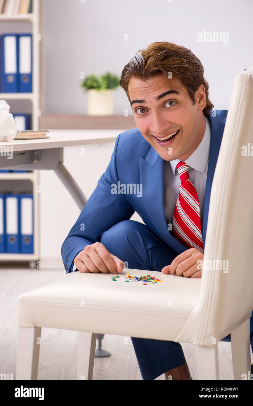 Office prank with sharp thumbtacks on chair Stock Photo Alamy