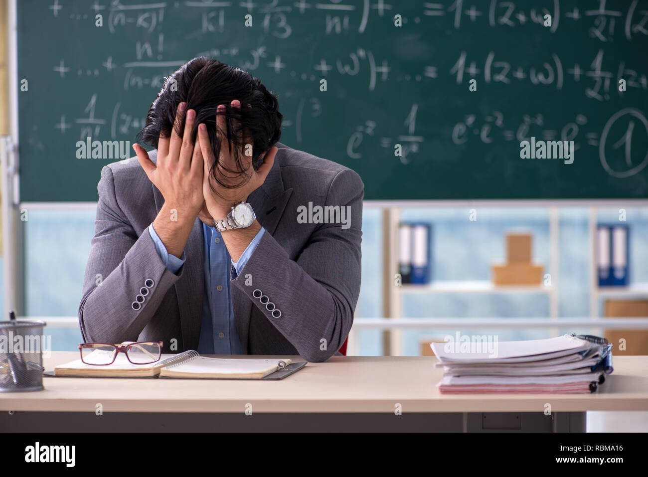 Young handsome math teacher in classroom Stock Photo