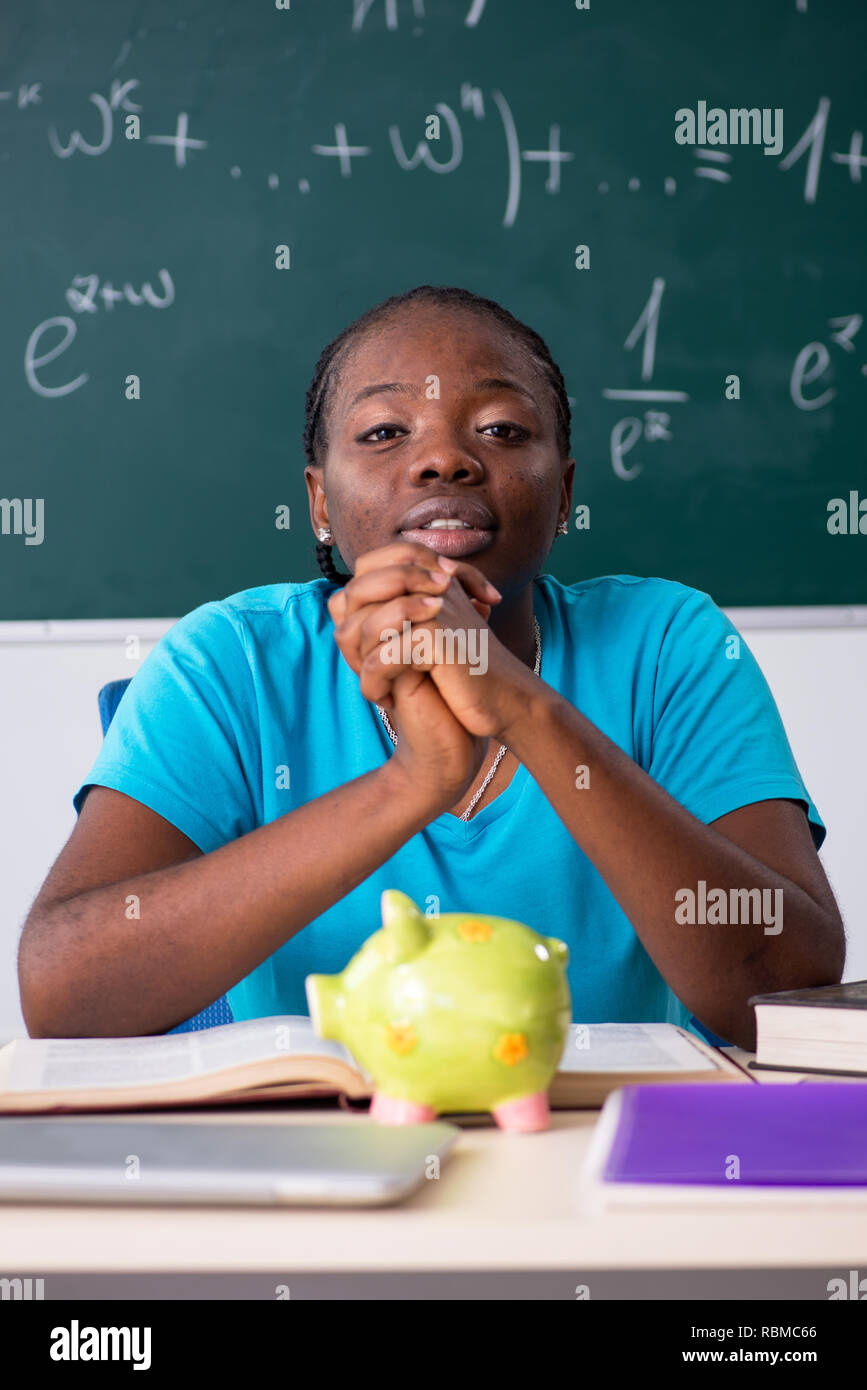 Black female student in front of chalkboard Stock Photo - Alamy