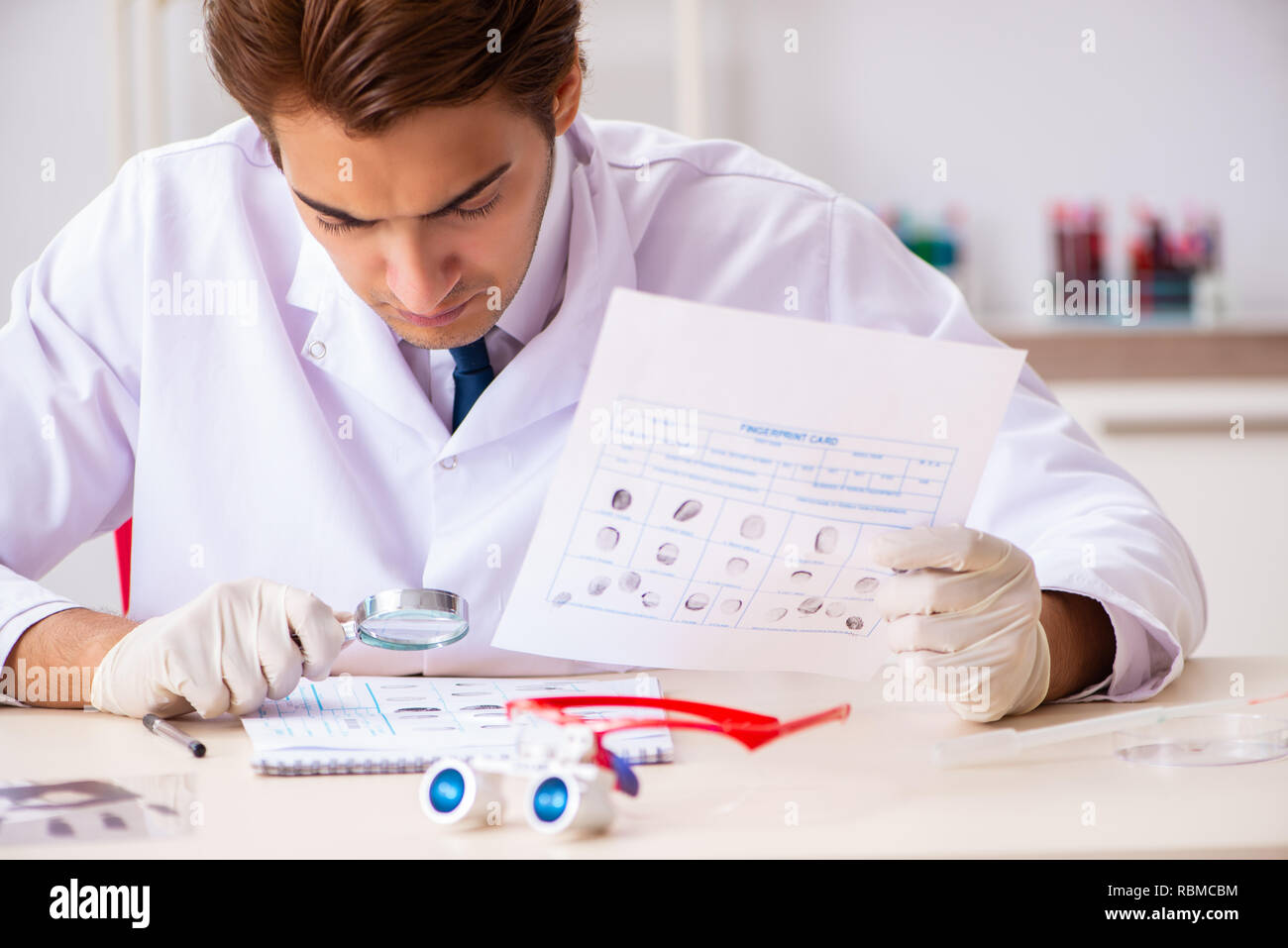 Forensic Expert Studying Fingerprints In The Lab Stock Photo - Alamy