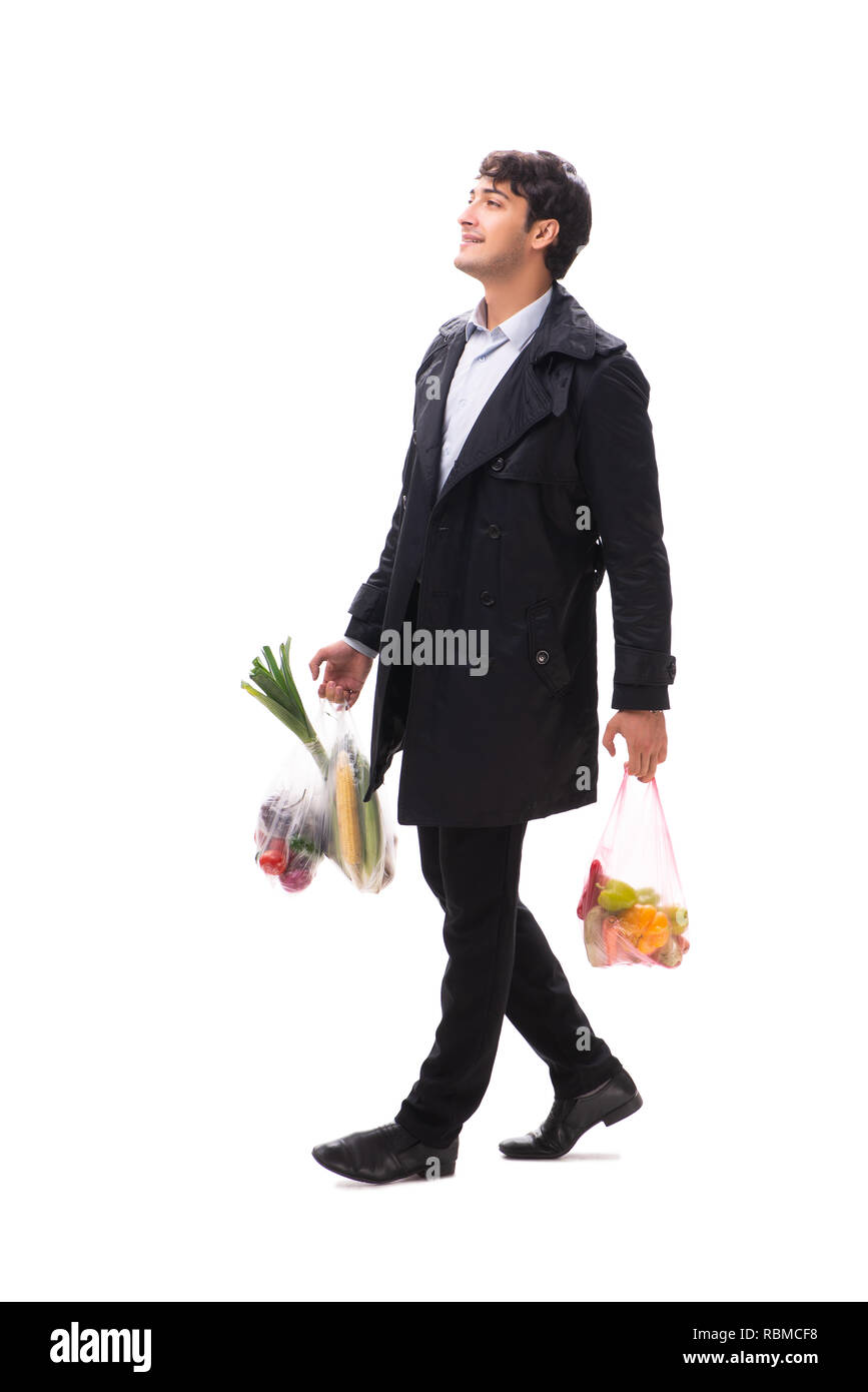 Young handsome man with vegatables in shopping concept Stock Photo