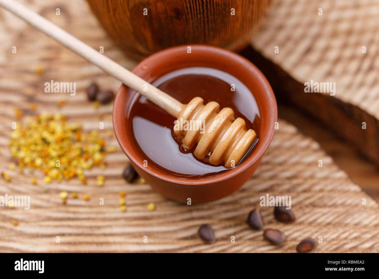 Flower pollen on a wooden textured background and stick with fragrant ...