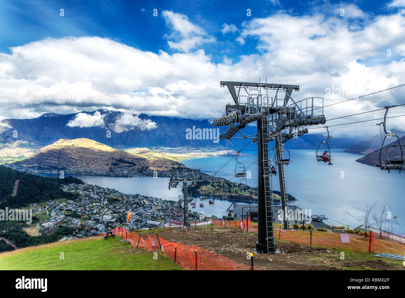 Cable car lift for luge riders and view of Wakatipu lake and Queenstown in New Zealand Stock Photo