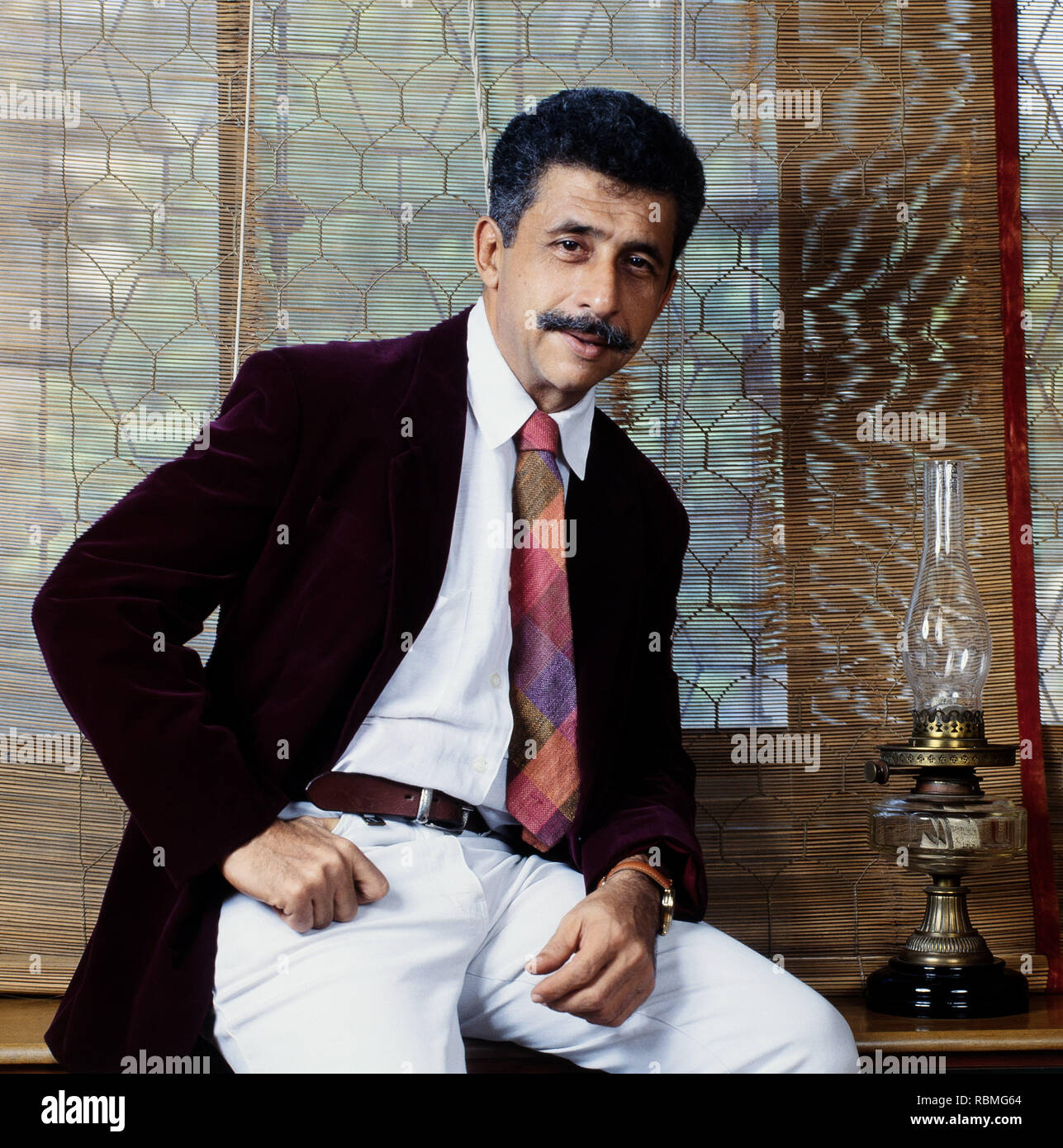 Portrait of Naseeruddin Shah sitting on table, India, Asia Stock Photo
