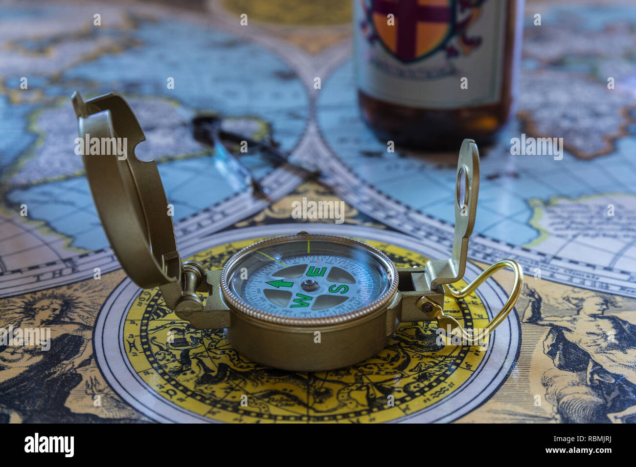 old world map with charting tools, compass, and beer bottle Stock Photo ...