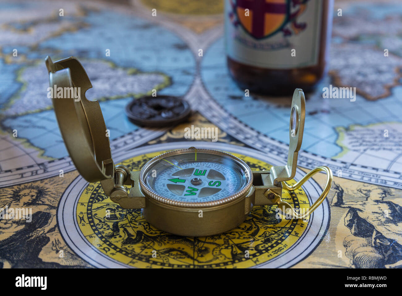old world map with ancient coin, compass, and beer bottle Stock Photo ...