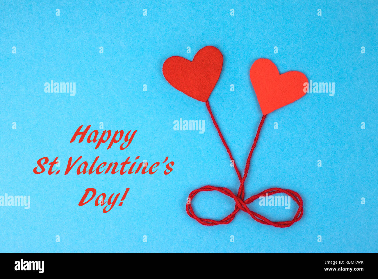 Two felt hearts on a blue background. Stock Photo