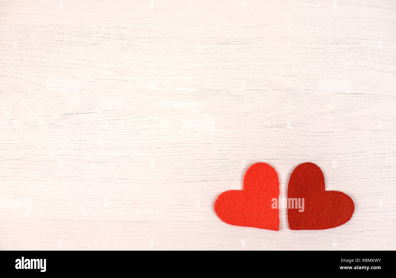 Two felt hearts on a wooden background. Stock Photo