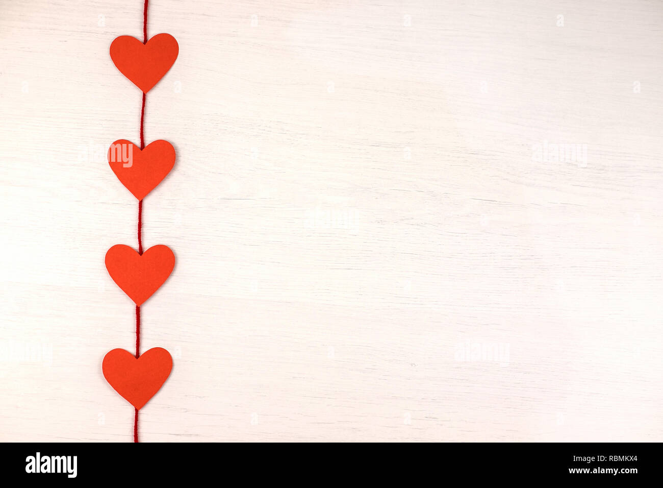 Paper red hearts on a white background Stock Photo - Alamy