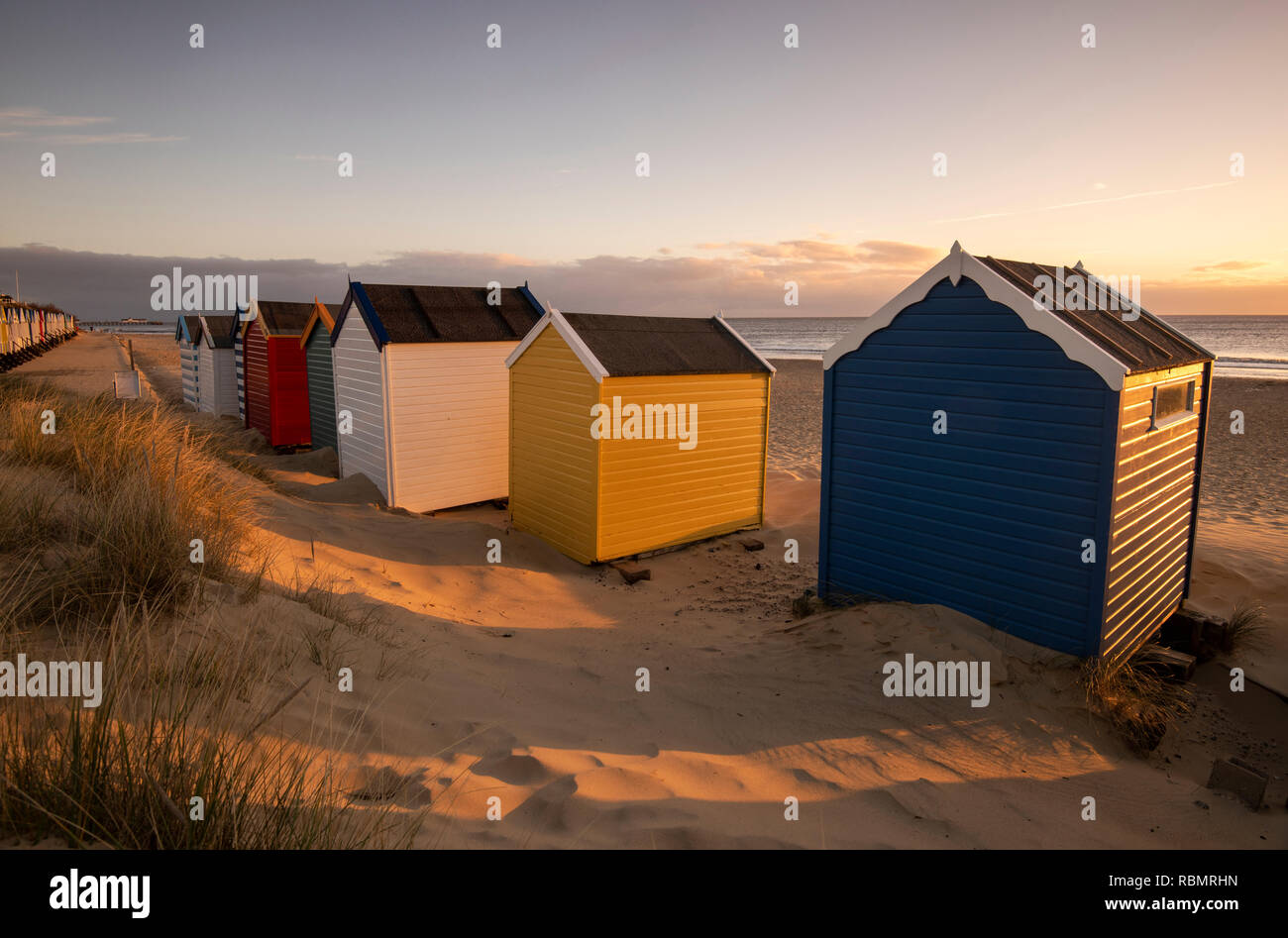 Golden sunrise over the Beach Huts at Southwold in Suffolk, England UK