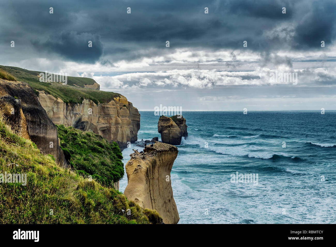 Dramatic view of high sandy cliffs at Tunnel beach, Otago, New Zealand Stock Photo Alamy
