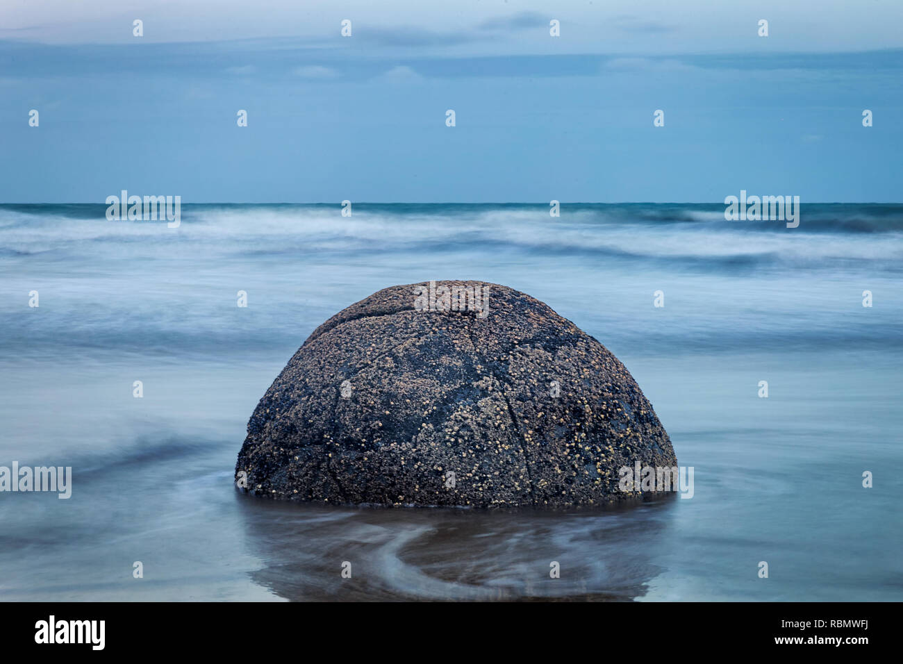Evening view of perfect spherical stone at Moeraki boulders beach, New Zealand Stock Photo