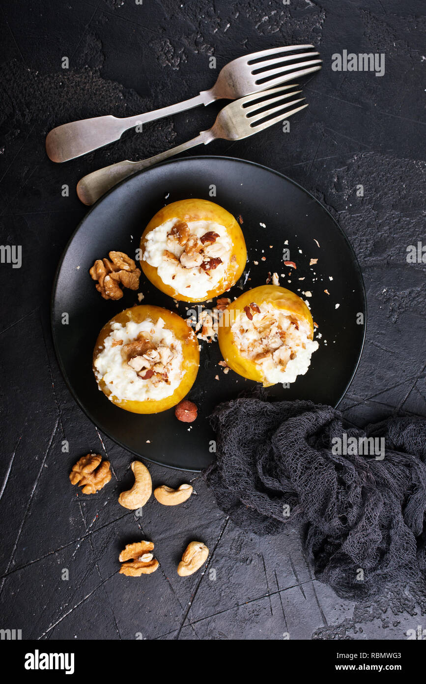 baked apples with nuts and honey, desert on plate Stock Photo
