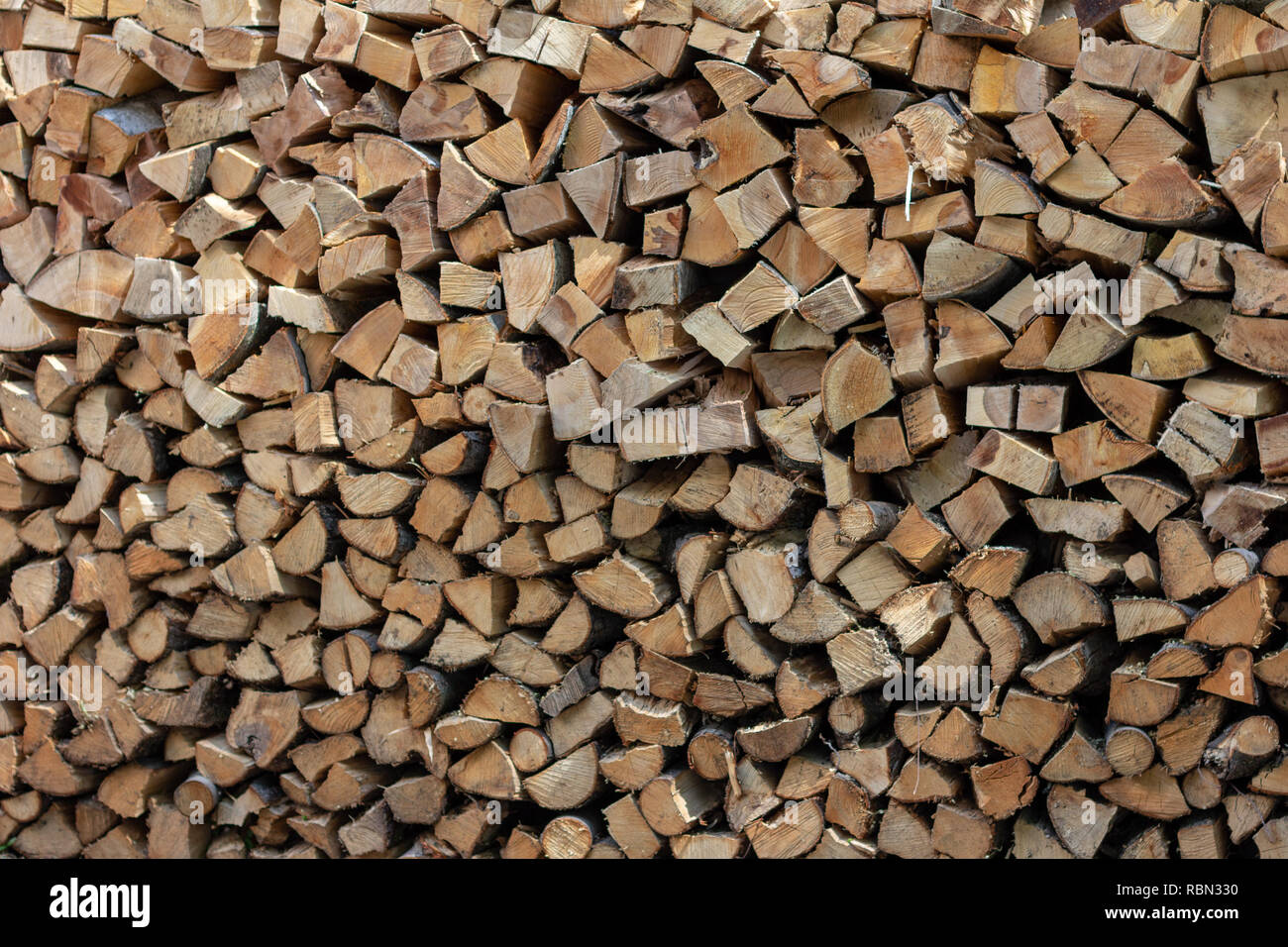 A stack of firewood sits in a pile ready for burning Stock Photo