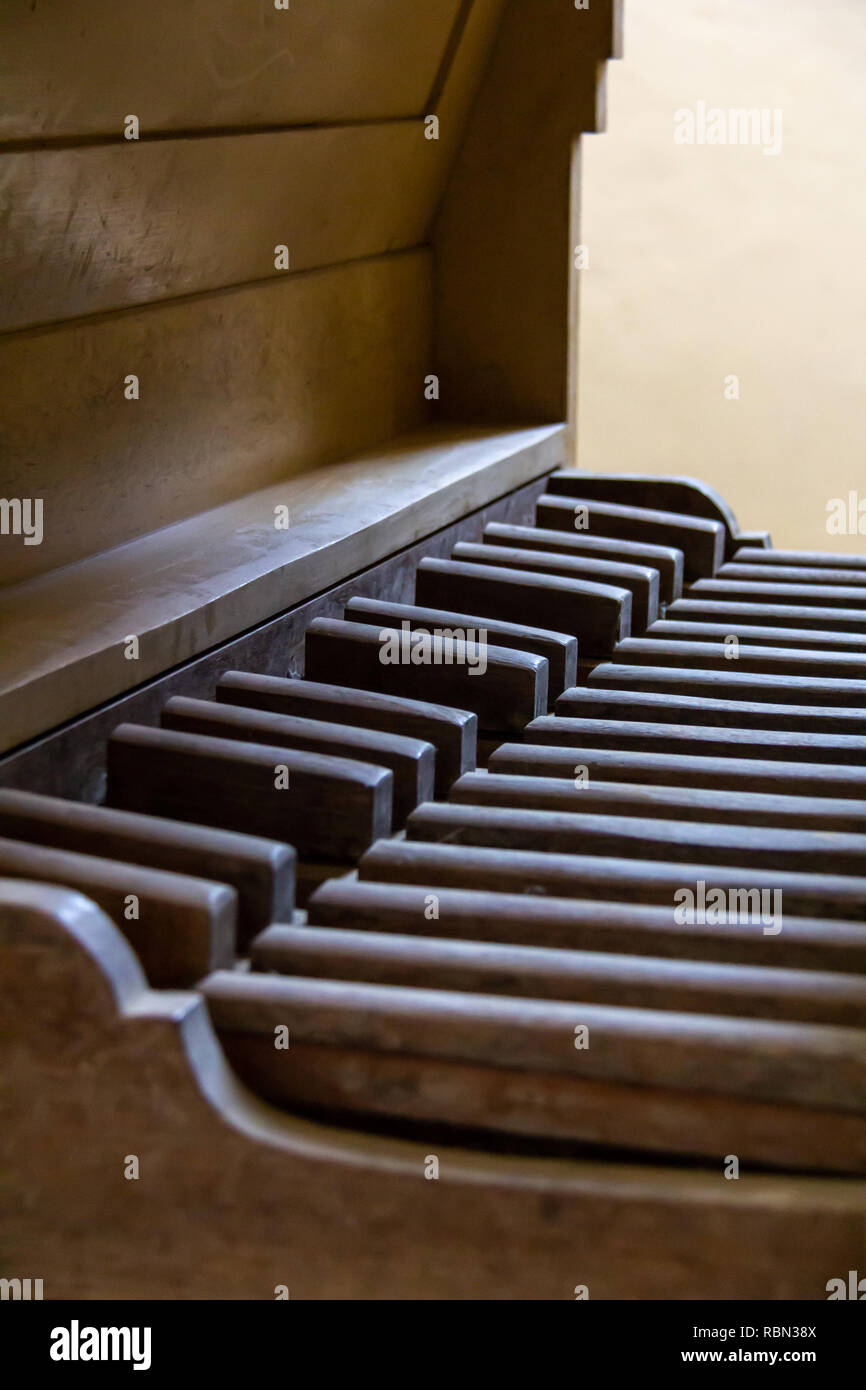 The wooden pedalboard of a vintage pipe organ in profile Stock Photo
