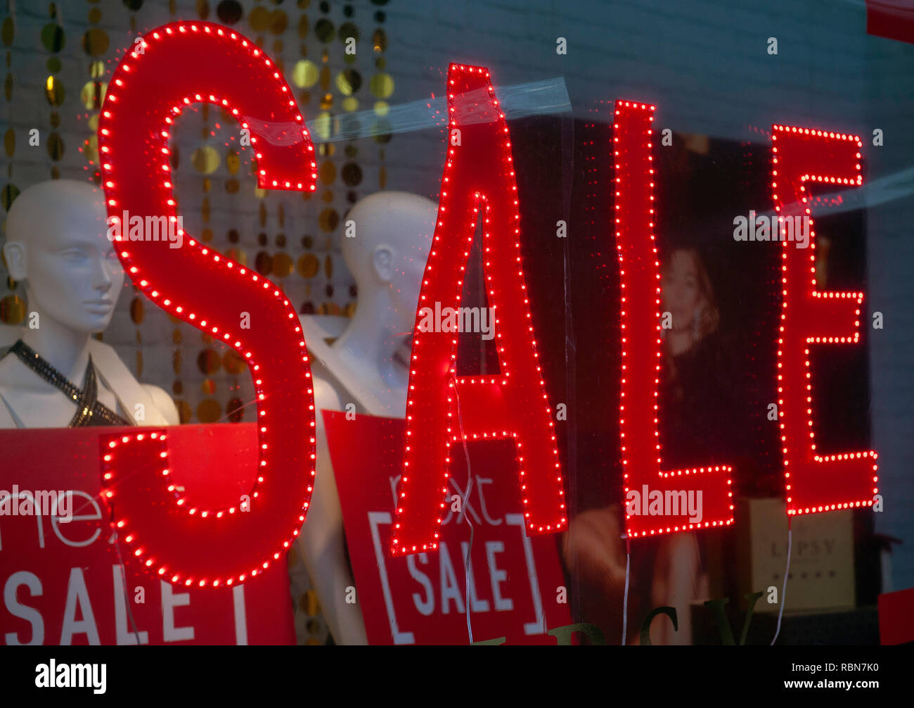 Red neon Sale sign in shop window Stock Photo