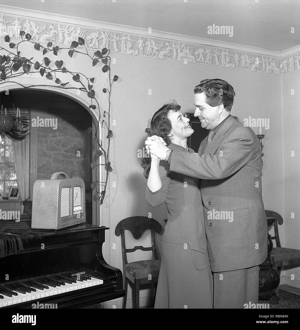 Dancing in the 1950s. A couple at home is dancing to music from their radio reciever.  Photo Kristoffersson Ref BF58-8. Sweden 1950s Stock Photo