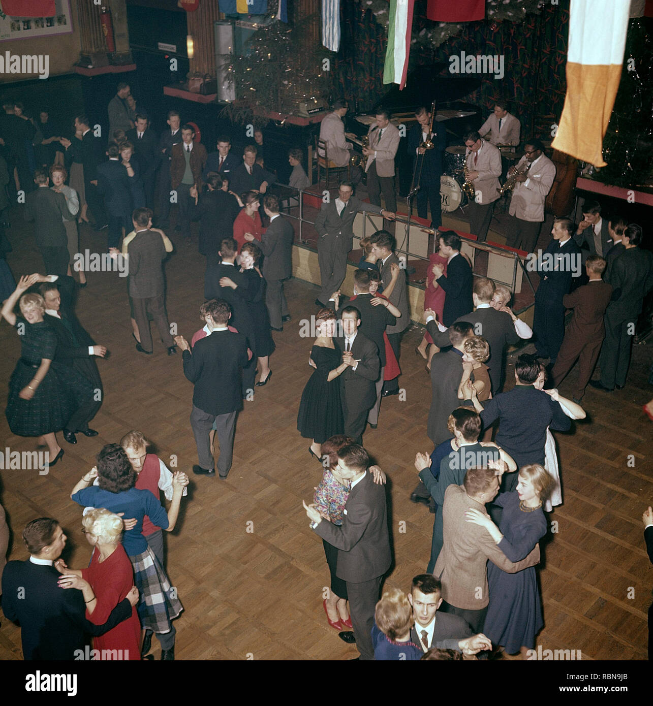 Dancing in the 1950s. The dance floor is filled with well dressed dancing  couples, moving to the music at a club. A jazz band is playing on stage. Nalen Stockholm Sweden 1950s Stock Photo