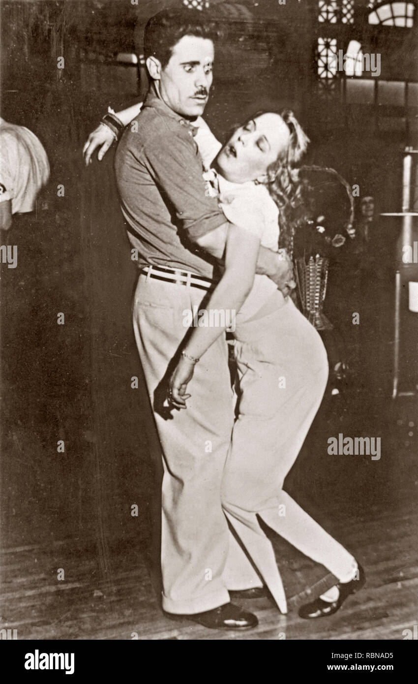 Dancing in the 1930s. A dance couple where he looks surprised when his dance partner faints in his arms, perhaps totally exhausted by the dancing. 1930s Stock Photo
