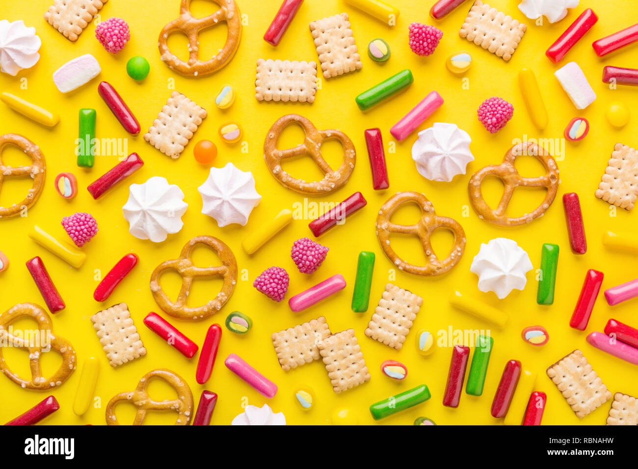 Flat Lay of Tasty Colorful Sweets on Yellow Background. Party Happy Birthday Concept. Sweet Pattern. Stock Photo