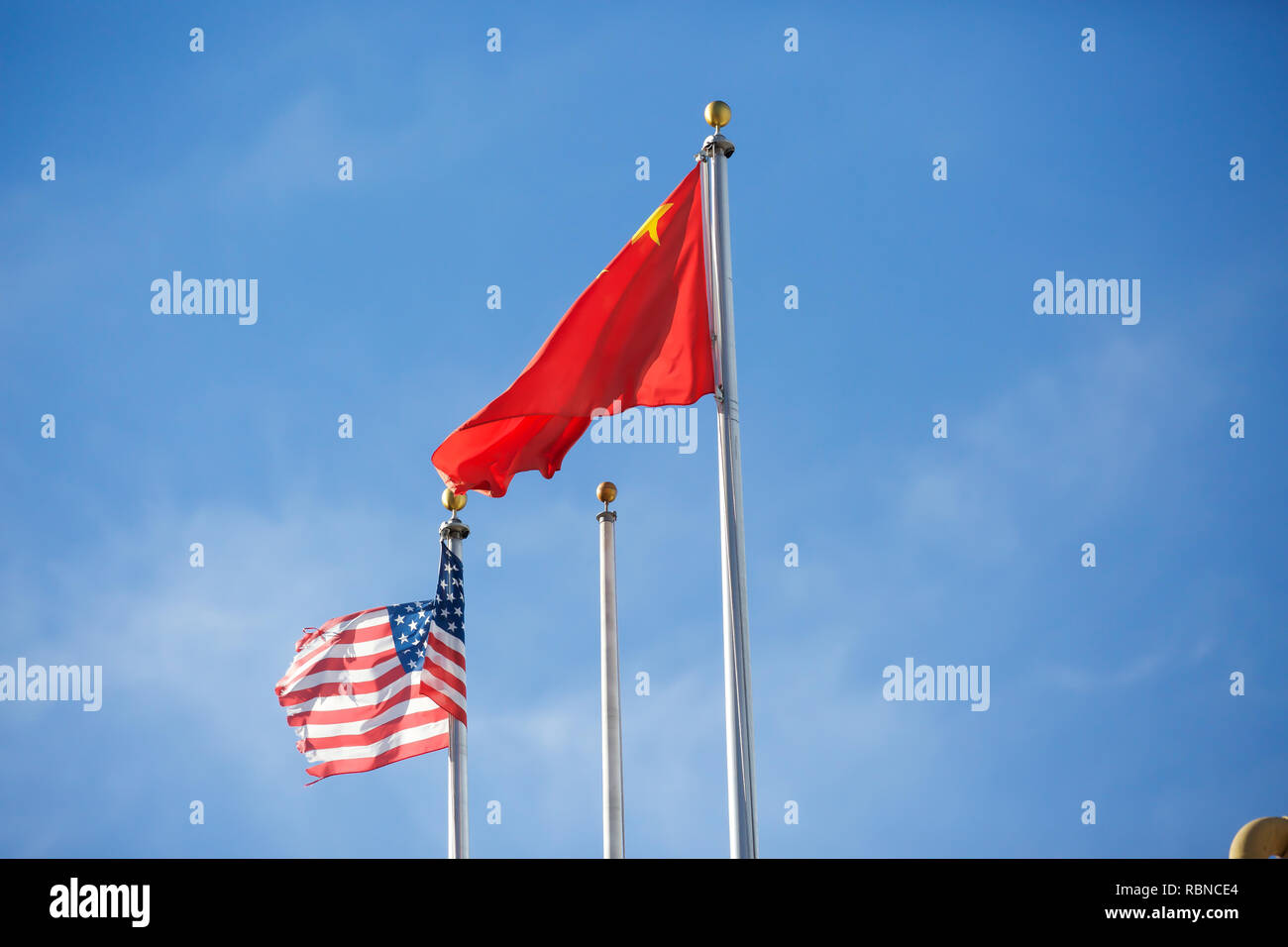 The Chinese and American flags flying in San Francisco, USA Stock Photo