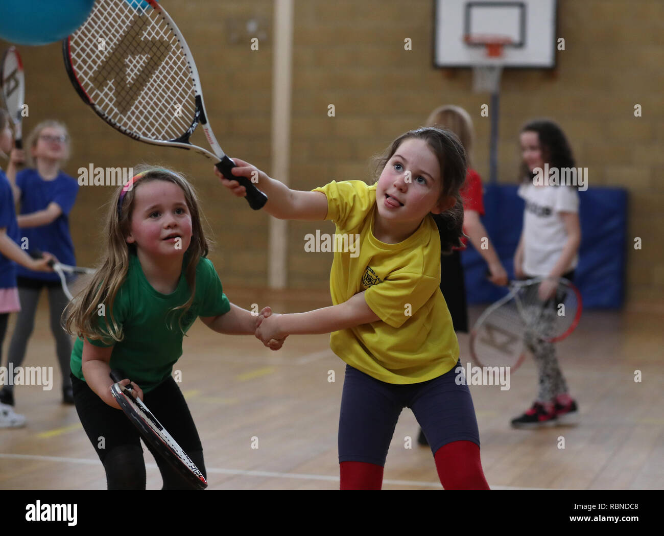 Primary three pupils Holly Anderson (left) with Emily Sorbie alongside classmates at Dunblane Primary as they take part in the schools Miss-hits tennis club in Andy Murray's home town, he has said he is aiming to end his career after Wimbledon but the Australian Open may be his last tournament. Stock Photo