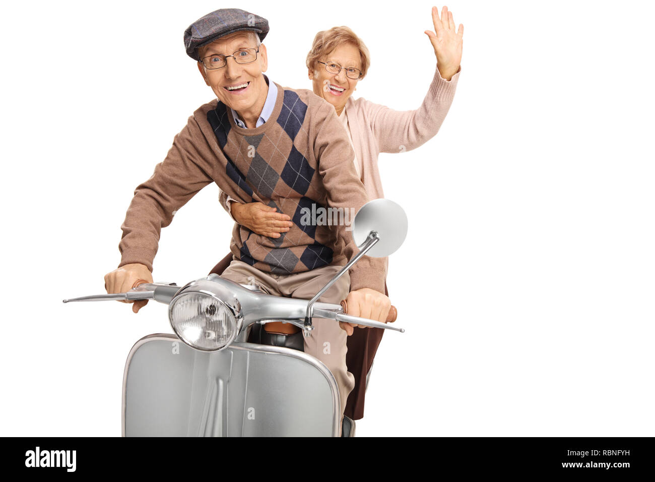 Elderly man and woman riding a vintage scooter and waving isolated on white background Stock Photo
