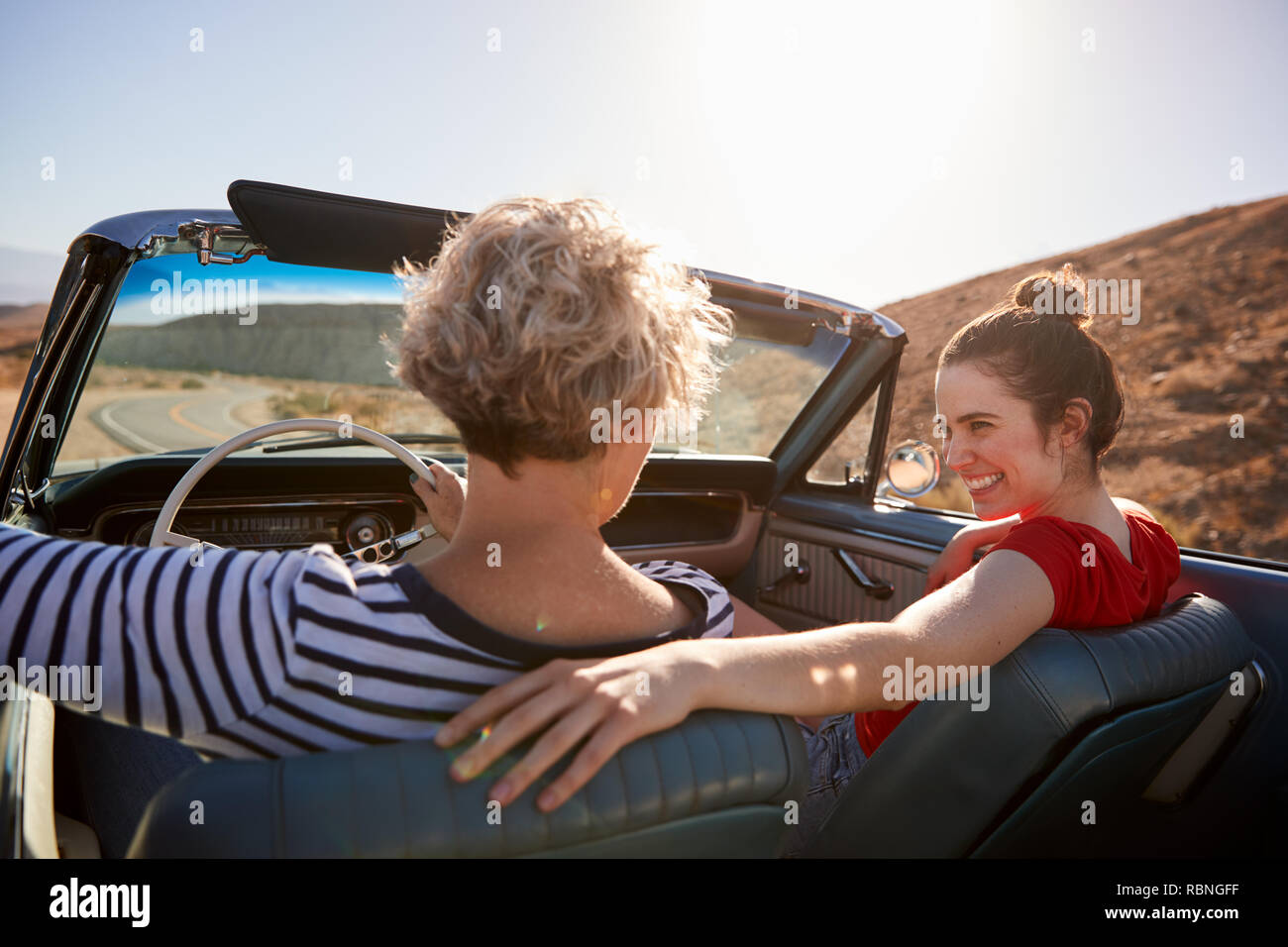 Mum and adult daughter in open top car, back view, close up Stock Photo