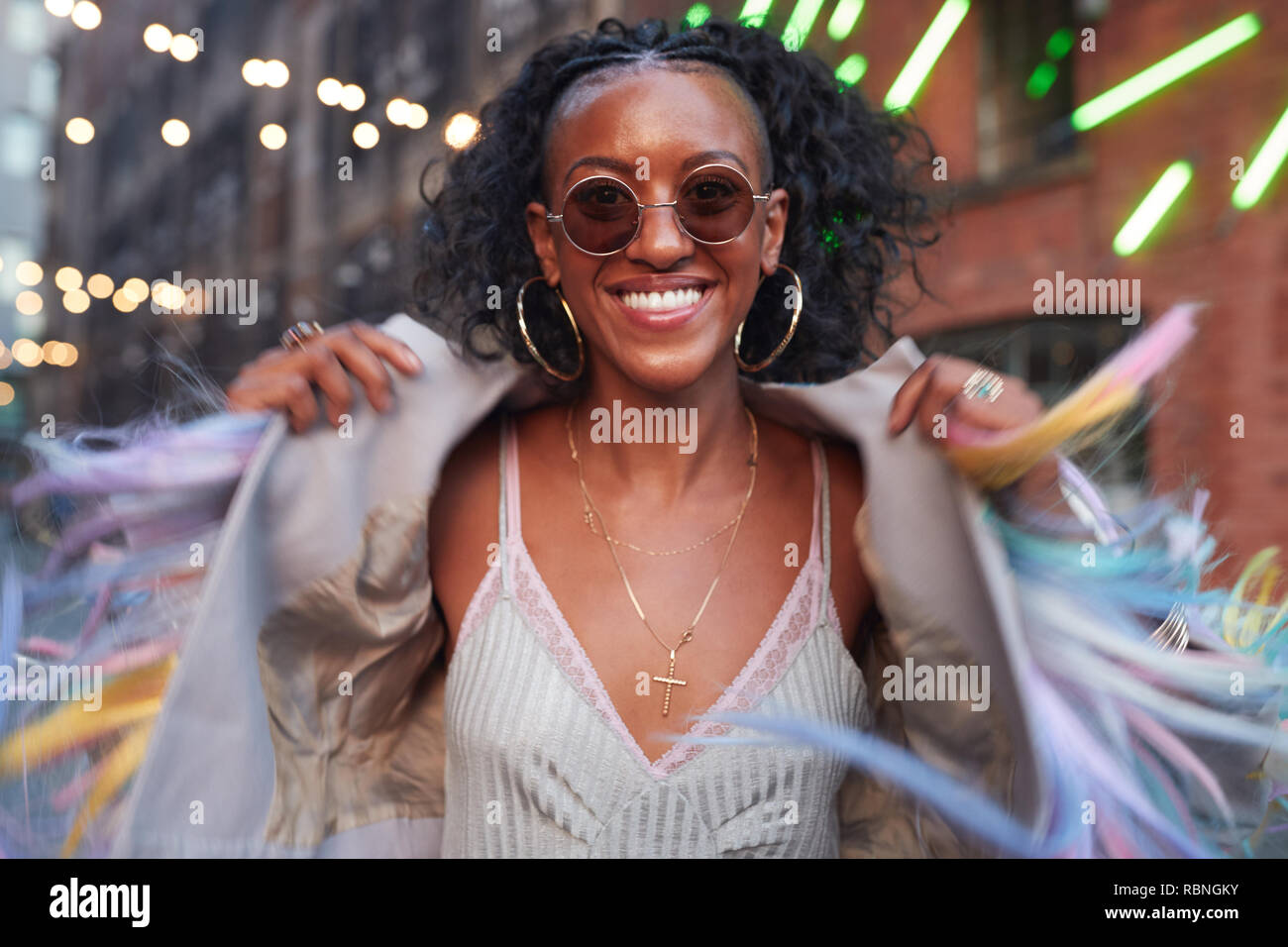 Trendy woman in striped camisole and fringed jacket Stock Photo