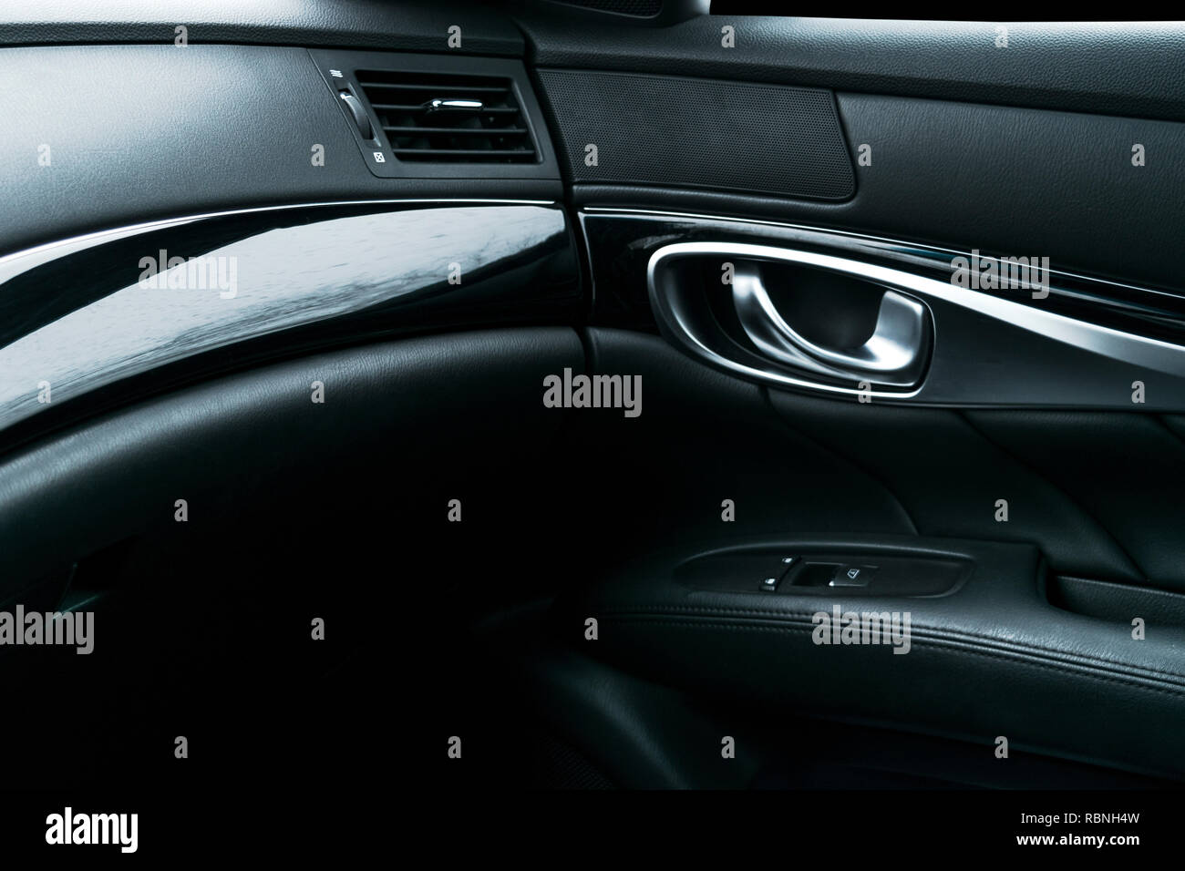 Car black perforated leather interior details of door handle with
